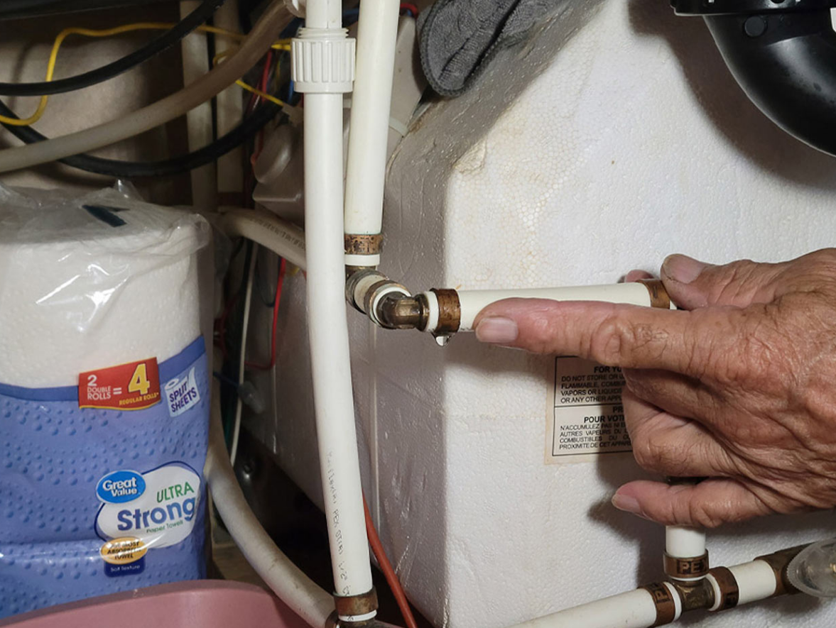 Emergency RV plumbing repair technician responding to a water leak at an RV in Port St. Lucie, Florida