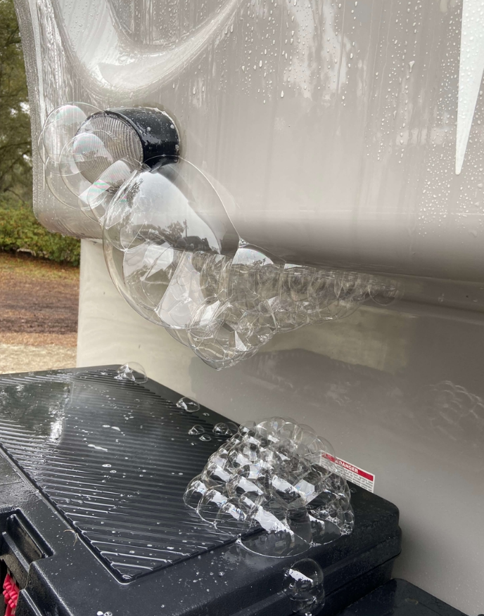 RV technician performing plumbing diagnostic on an RV water system
