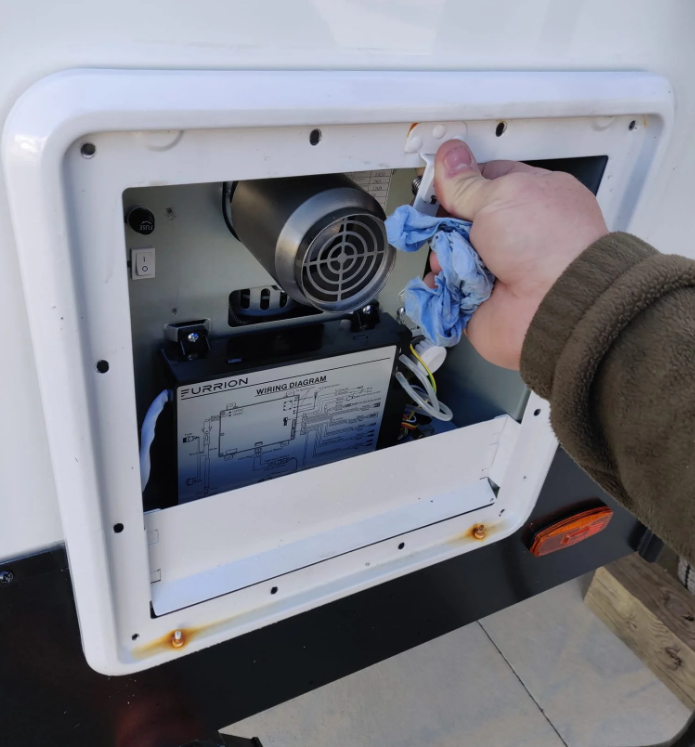 RV water pump replacement being performed on-site